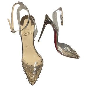 Christian Louboutin
Spikoo pumps with ankle strap in PVC and metallic pumps